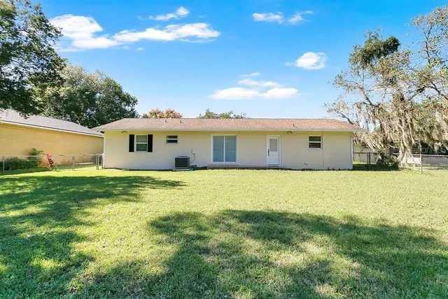 a view of an house with backyard space and balcony