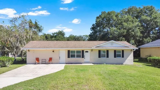 a front view of a house with a garden