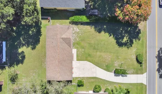 an aerial view of a house with a yard