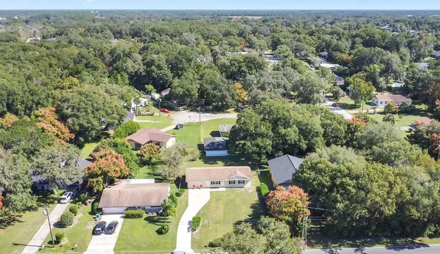 an aerial view of residential houses with outdoor space