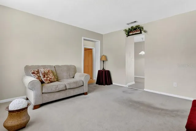 a living room with furniture and a lamp