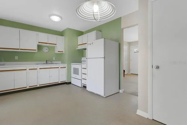 a kitchen with a refrigerator and a sink