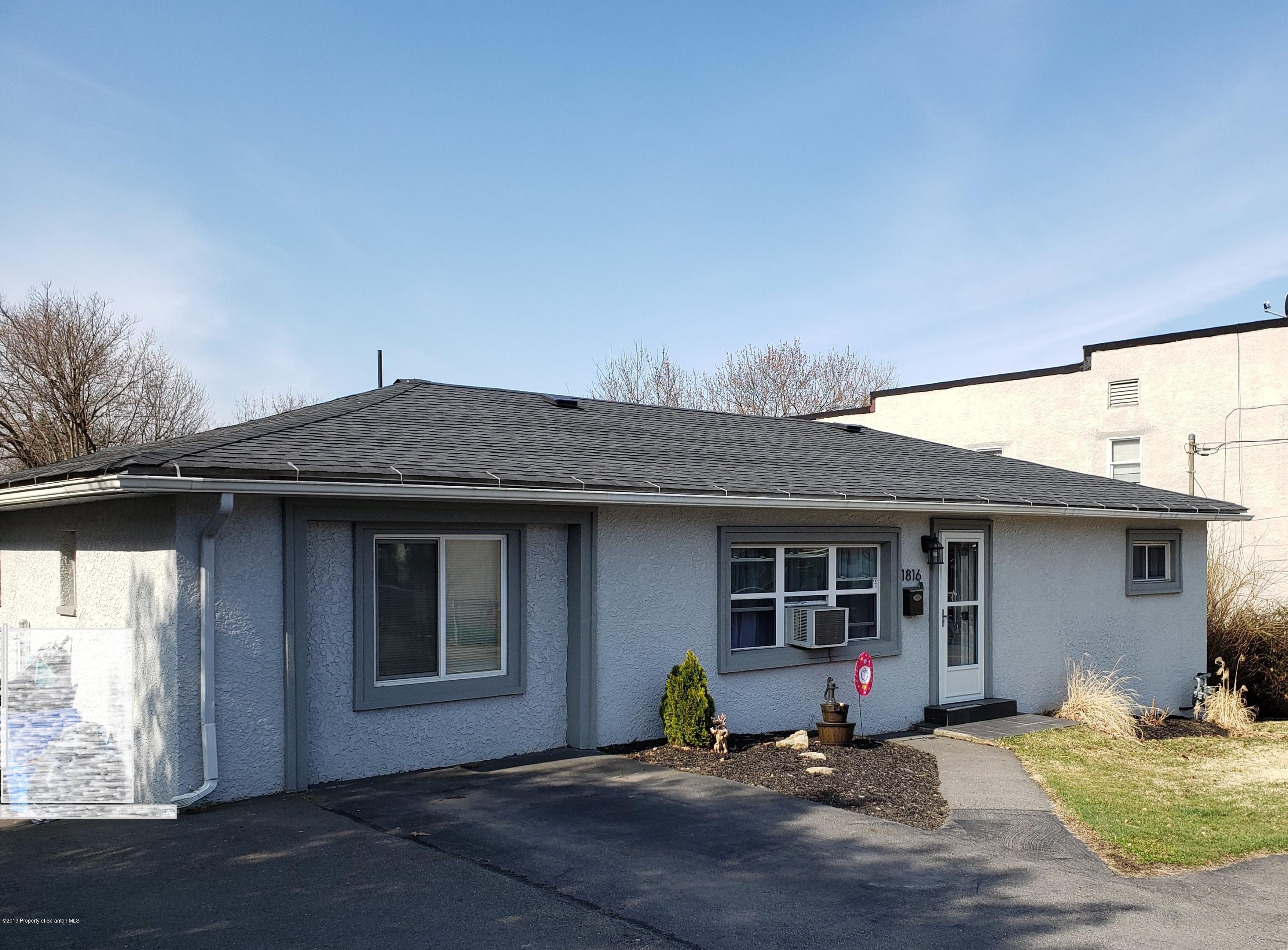 1816 Green Ridge Street Dunmore, PA 18509 - Photo 1 of 30 a front view of a house with a patio