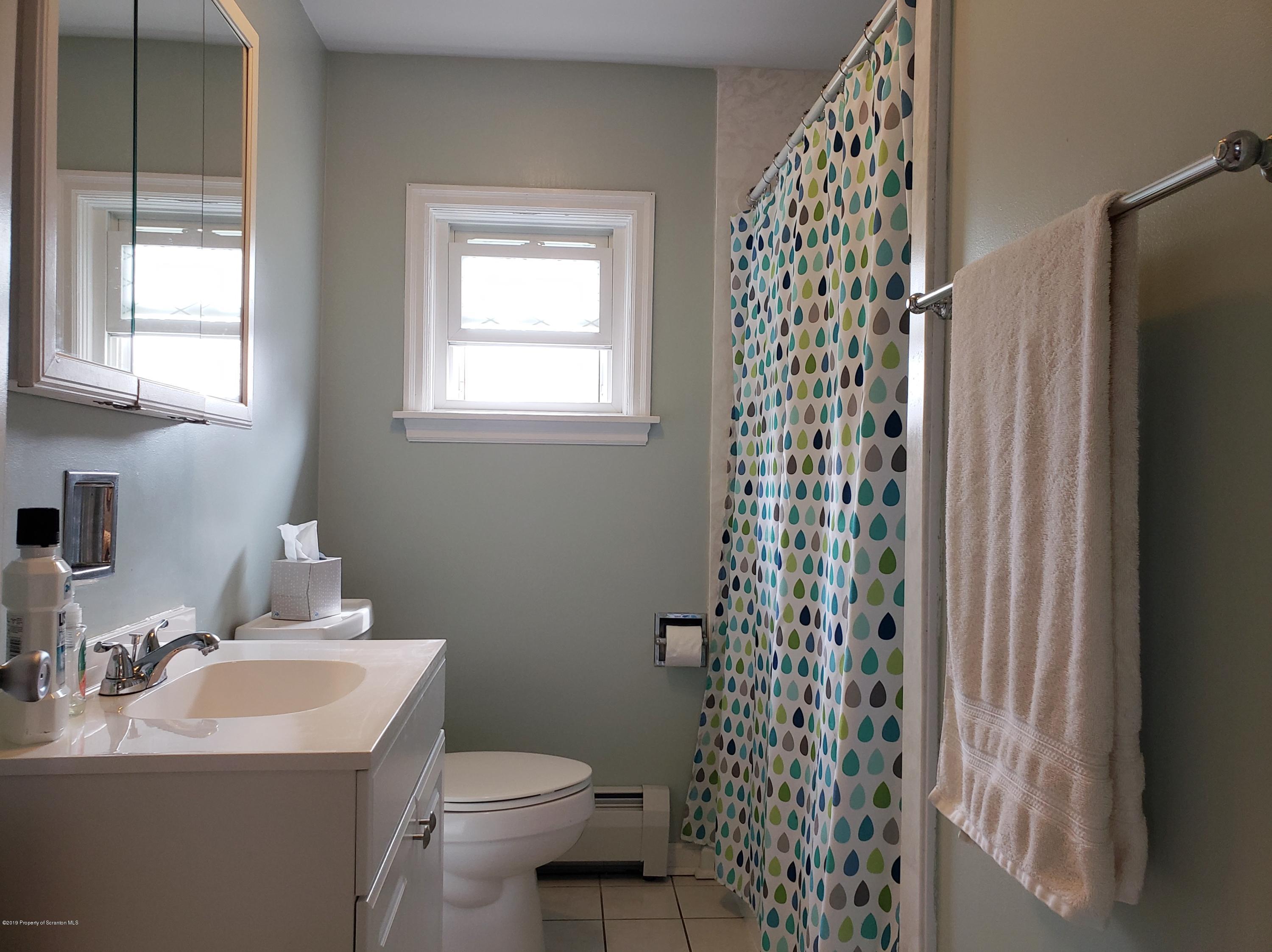 1816 Green Ridge Street Dunmore, PA 18509 - Photo 14 of 30 a bathroom with a sink toilet and shower