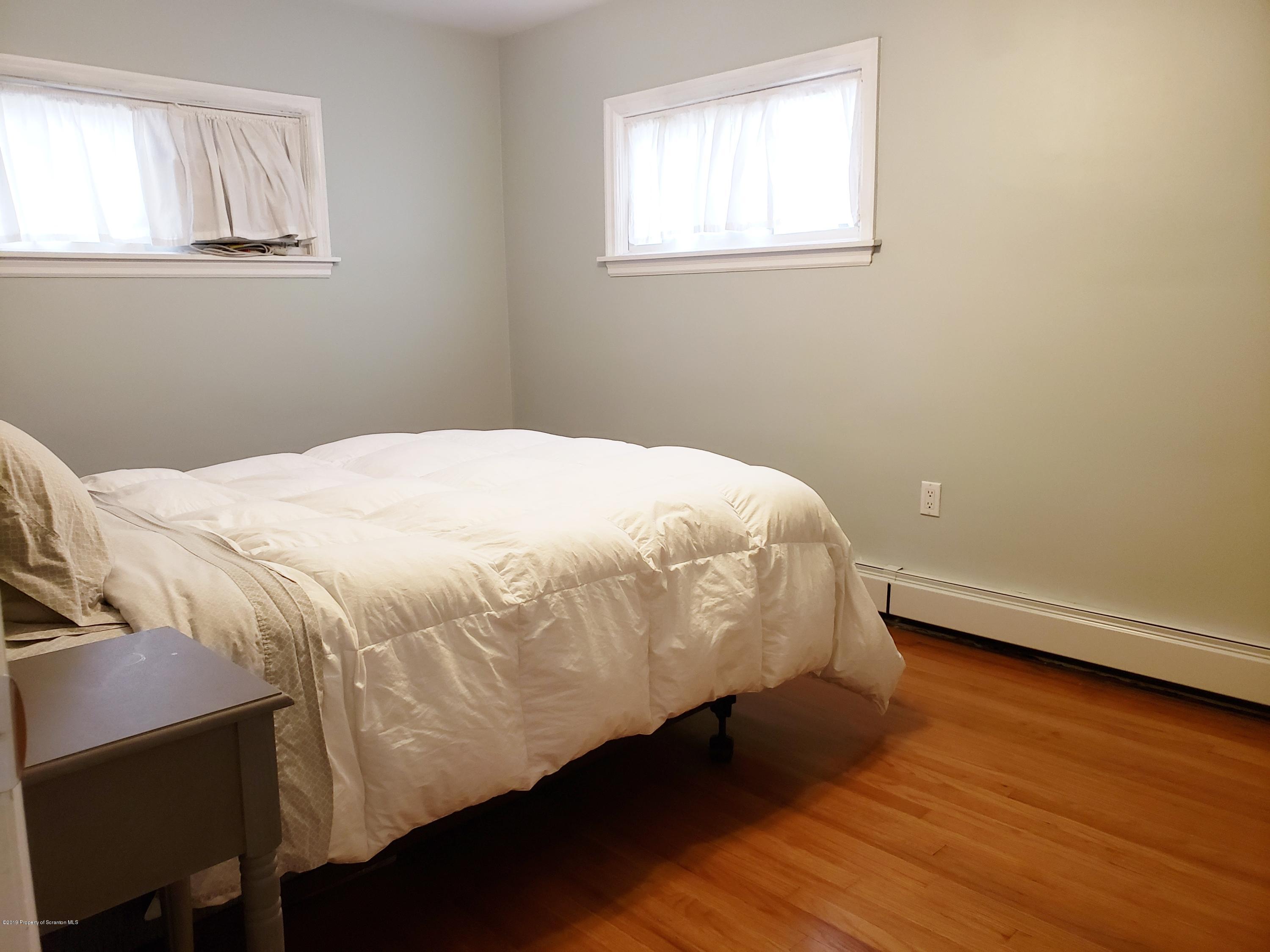 1816 Green Ridge Street Dunmore, PA 18509 - Photo 10 of 30 a bedroom with a bed and a window