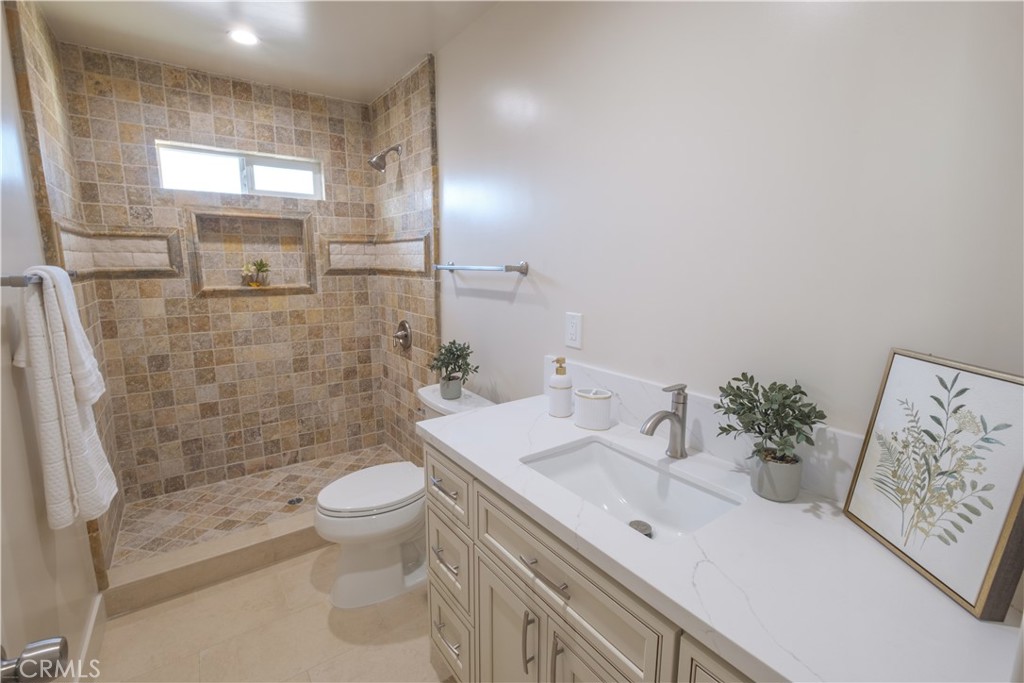 223 South Aprilia Avenue Compton, CA 90220 - Photo 23 of 46 a bathroom with a sink a toilet and shower