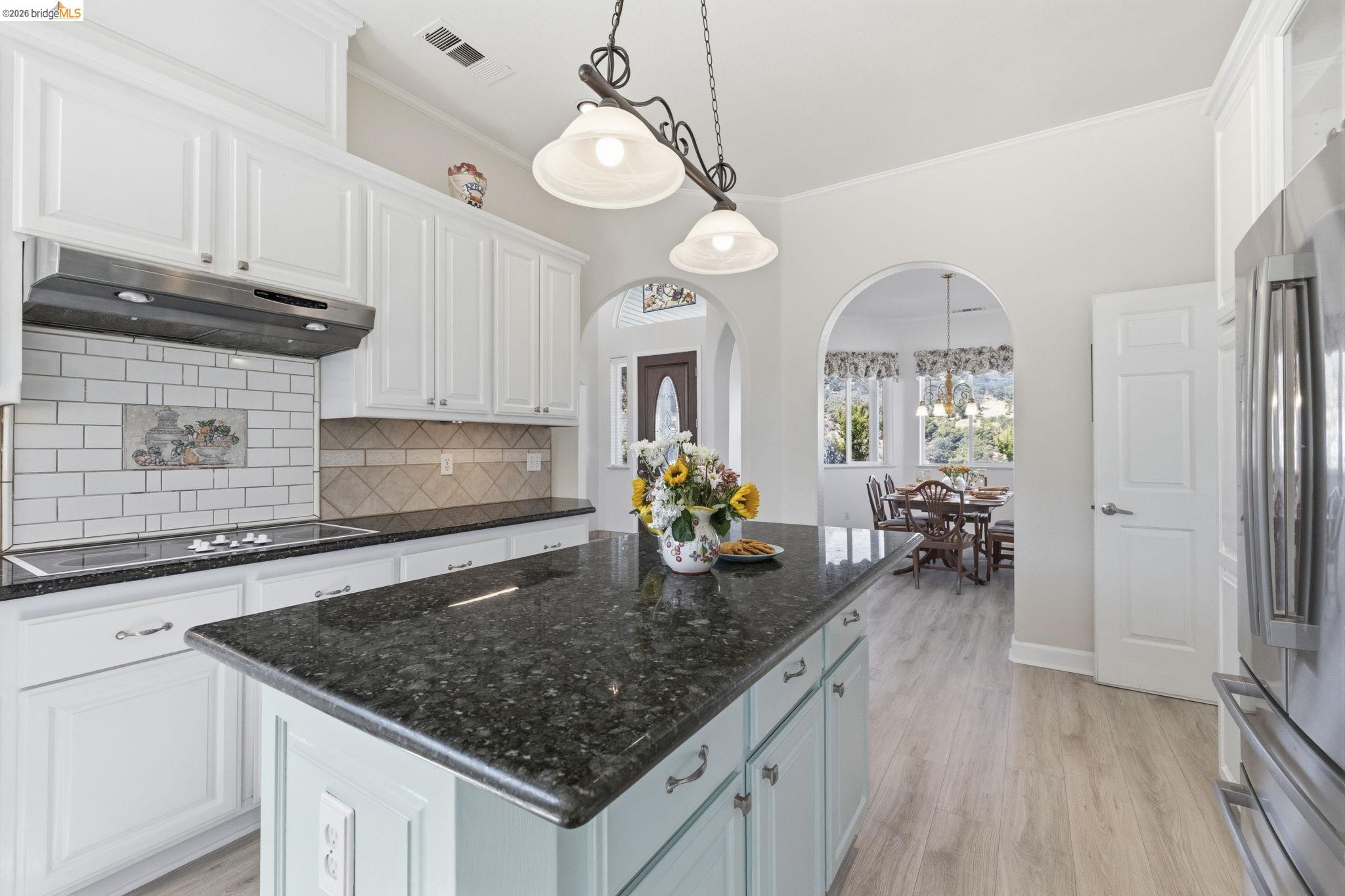 6242 Bluff View Road Copperopolis, CA 95228 - Photo 20 of 59 Kitchen featuring an expansive island with a dark countertop, light blue cabinetry, and overhead pendant lighting
