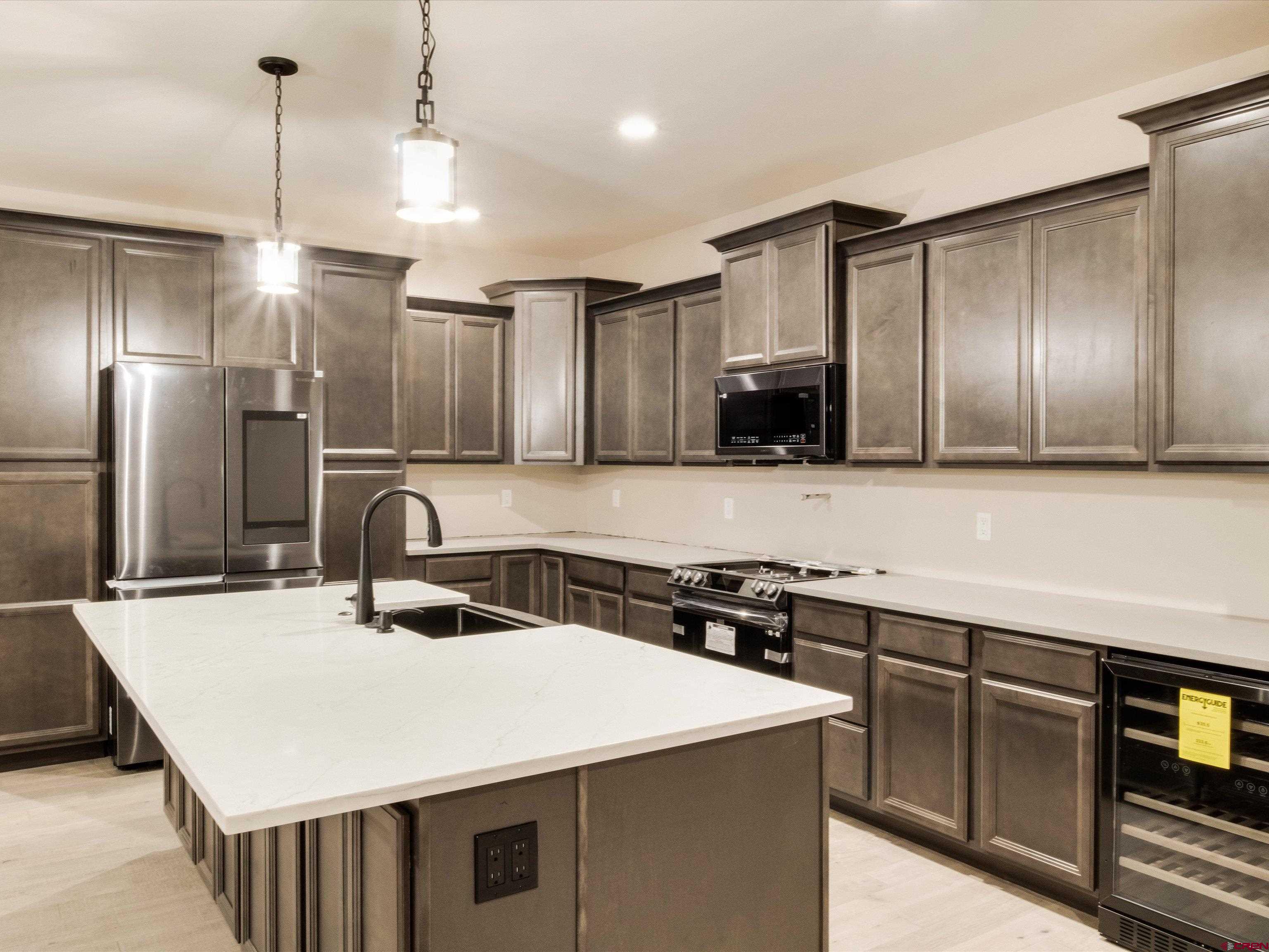 1900 Snaffle Bit Road Delta, CO 81416 - Photo 12 of 33 a kitchen with kitchen island a sink stainless steel appliances and cabinets