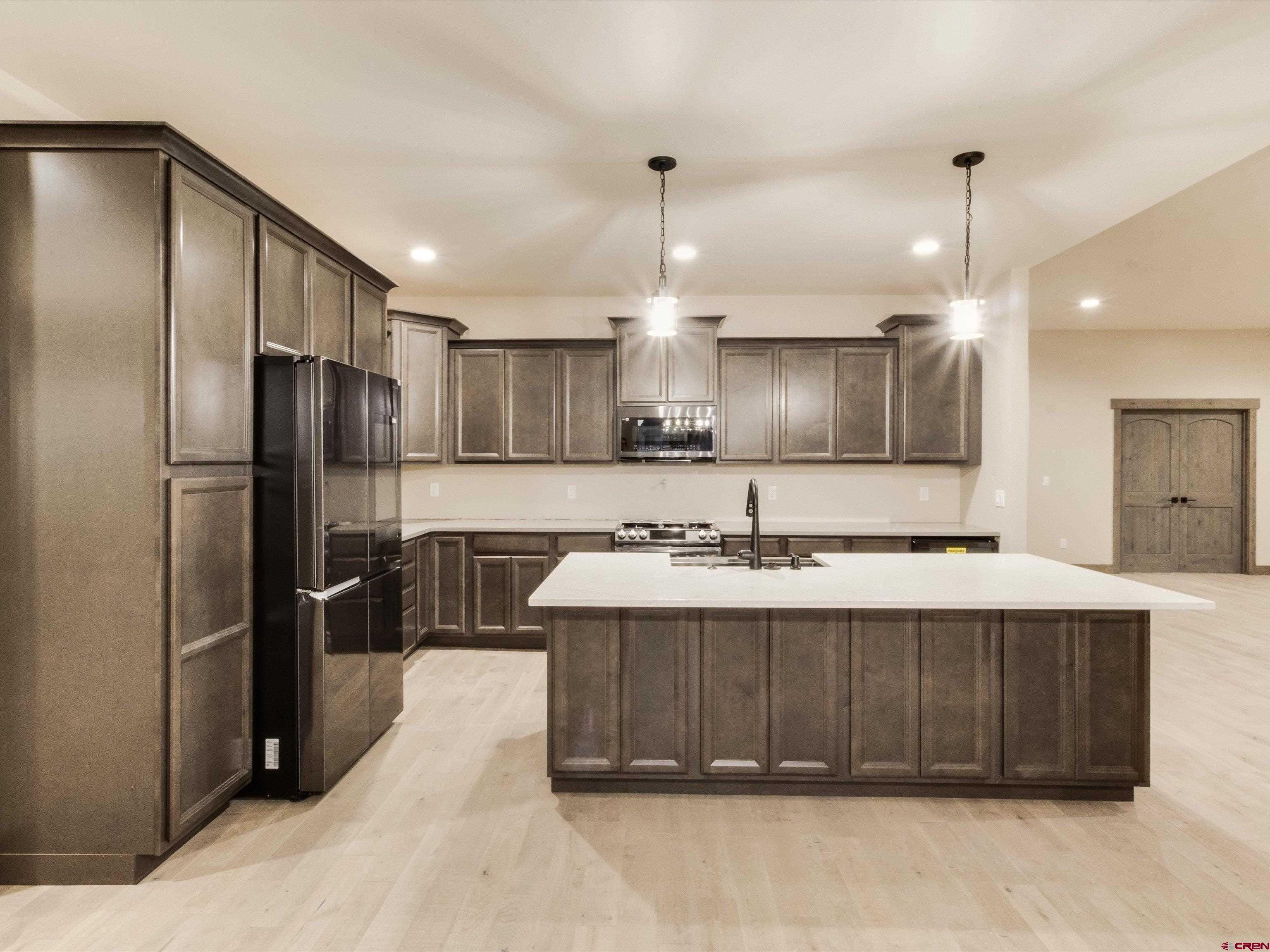 1900 Snaffle Bit Road Delta, CO 81416 - Photo 13 of 33 a kitchen with a sink stainless steel appliances and cabinets