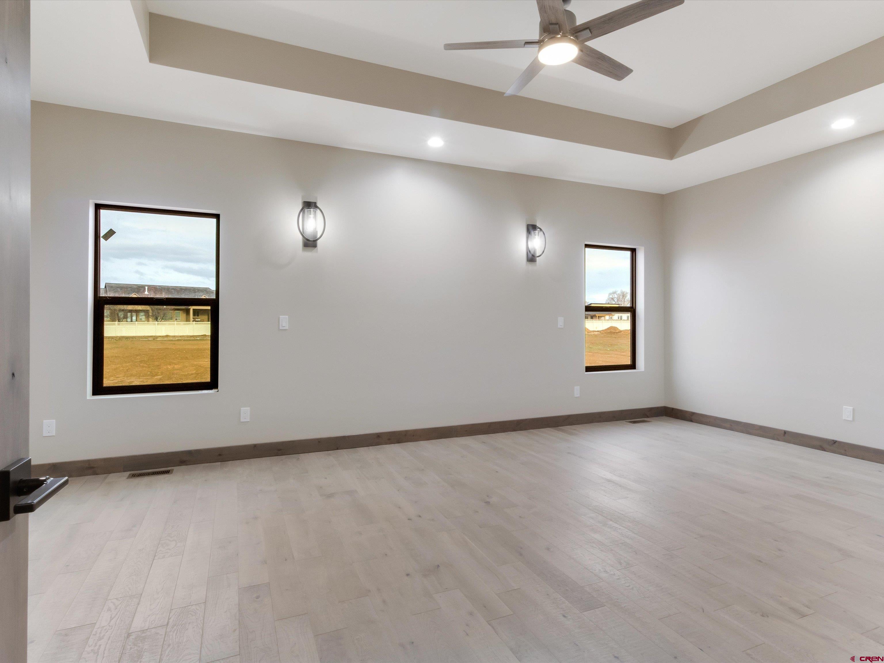 1900 Snaffle Bit Road Delta, CO 81416 - Photo 14 of 33 an empty room with windows and ceiling fan
