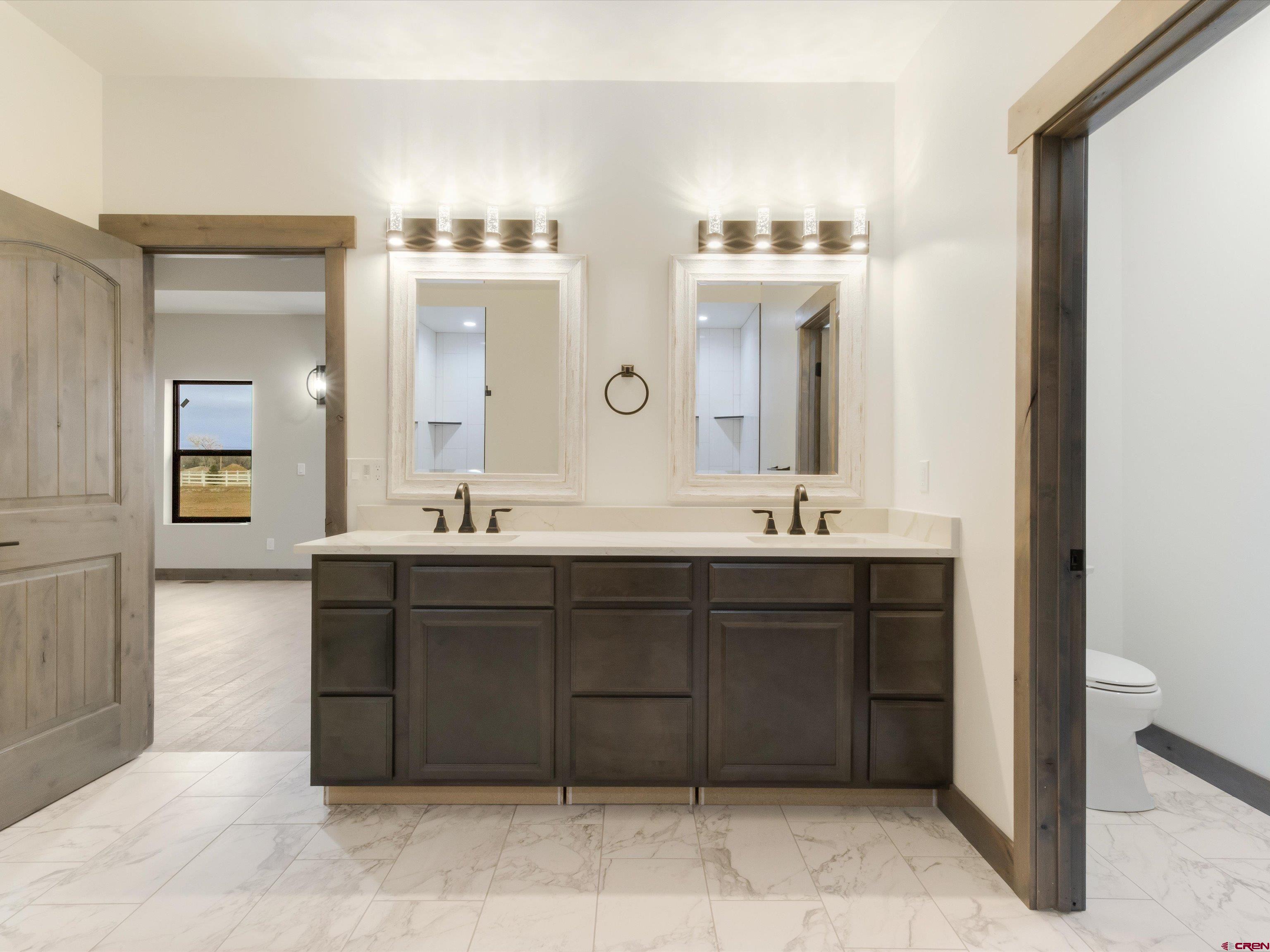 1900 Snaffle Bit Road Delta, CO 81416 - Photo 18 of 33 a bathroom with a sink vanity and mirror