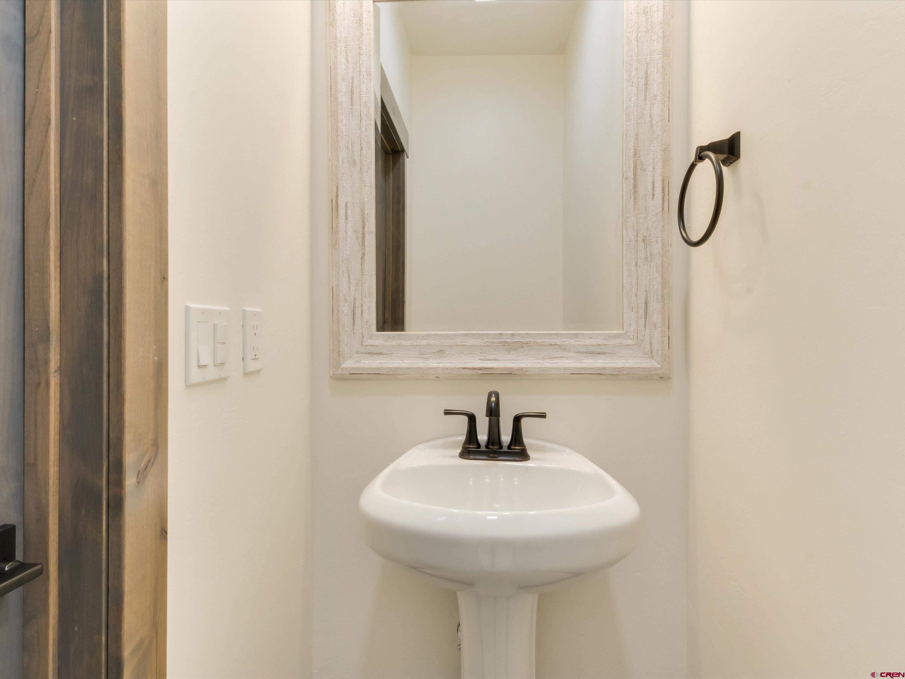 1900 Snaffle Bit Road Delta, CO 81416 - Photo 20 of 33 a bathroom with a sink and mirror