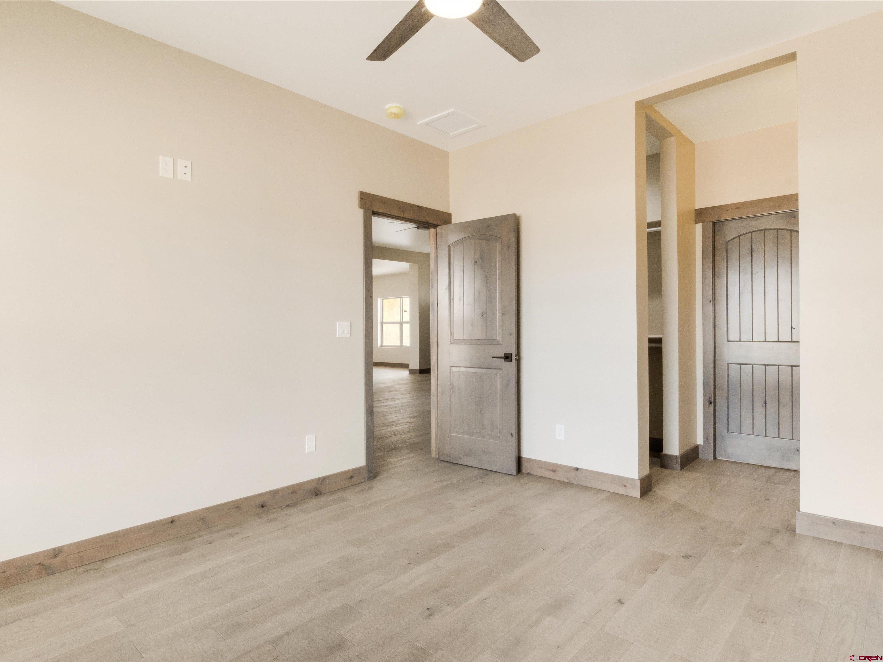 1900 Snaffle Bit Road Delta, CO 81416 - Photo 30 of 33 an empty room with closet and a chandelier fan