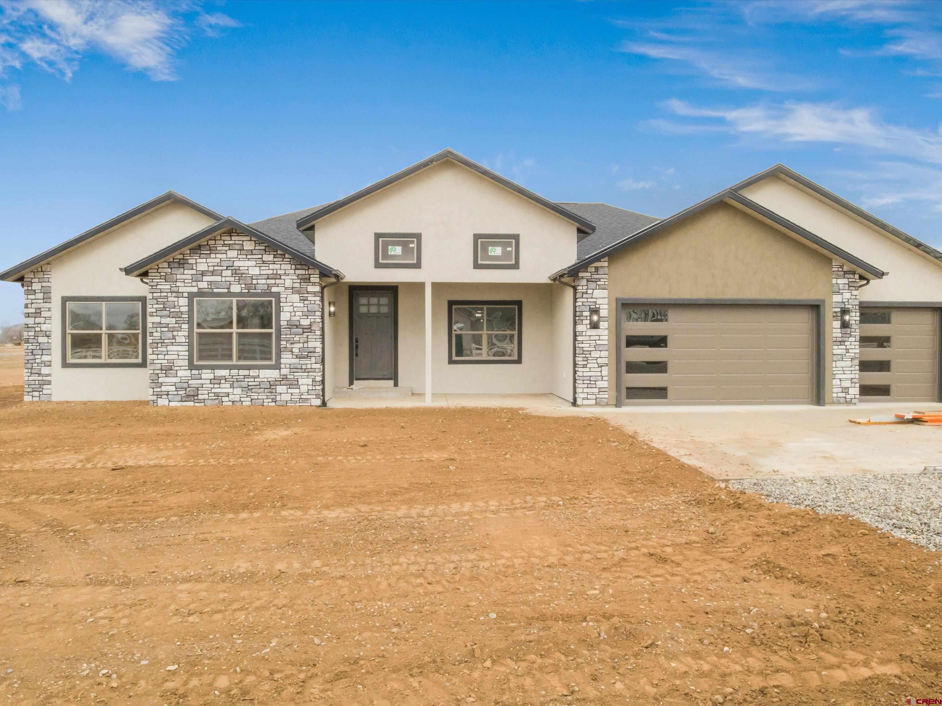 1900 Snaffle Bit Road Delta, CO 81416 - Photo 3 of 33 a front view of a house with a yard