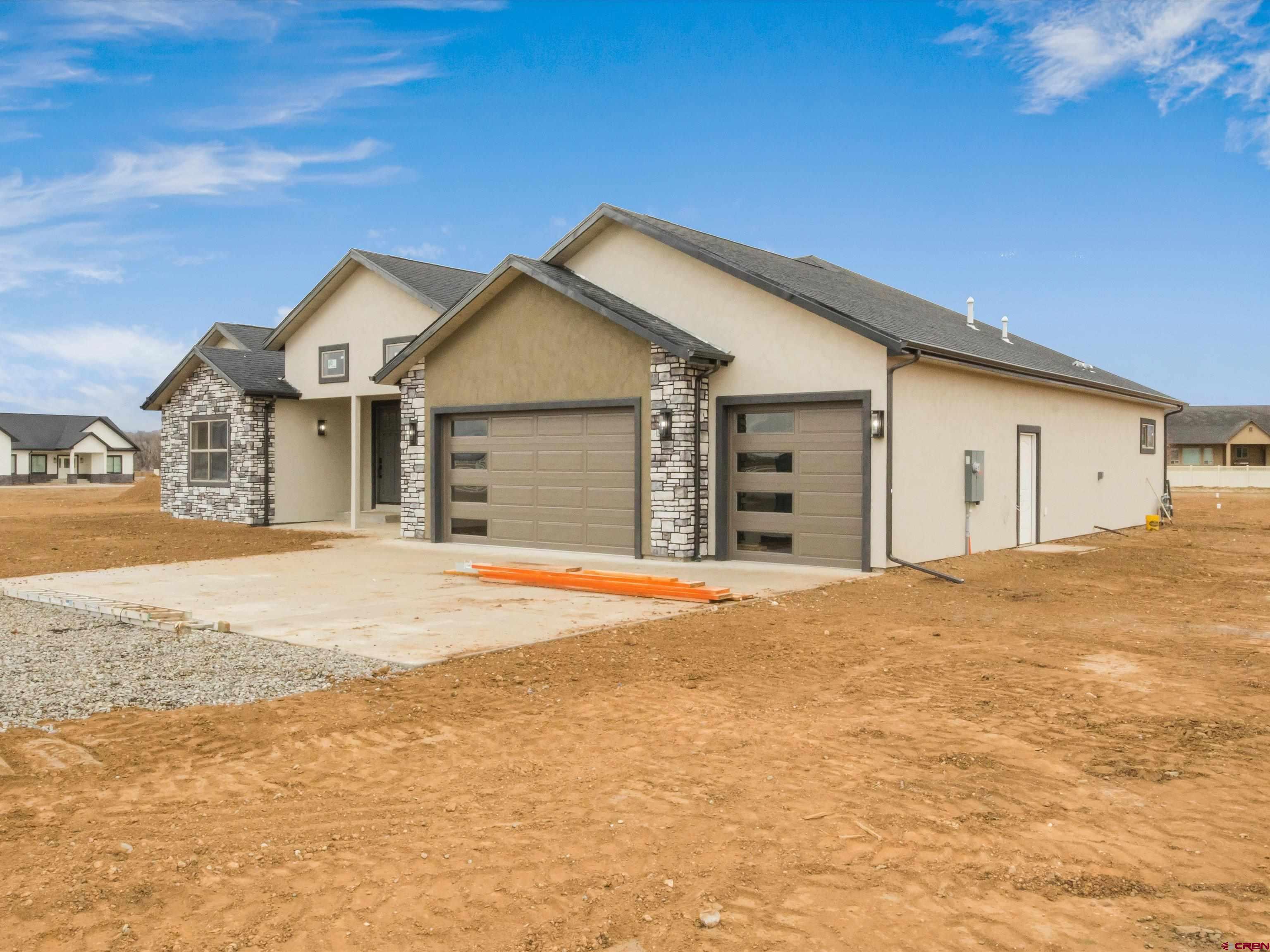 1900 Snaffle Bit Road Delta, CO 81416 - Photo 4 of 33 a view of a house with a yard and garage
