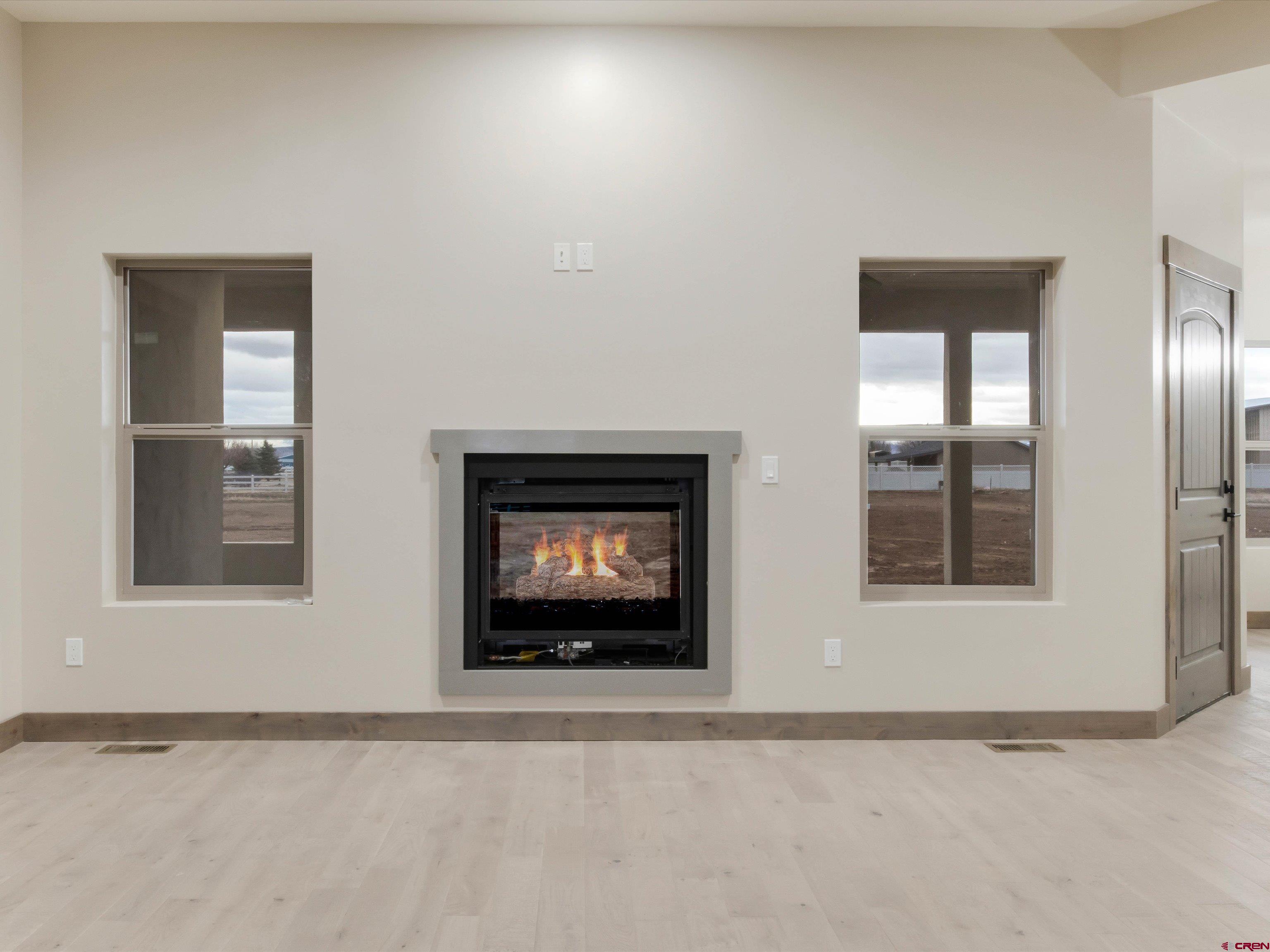 1900 Snaffle Bit Road Delta, CO 81416 - Photo 10 of 33 a view of an empty room with a fireplace and a window