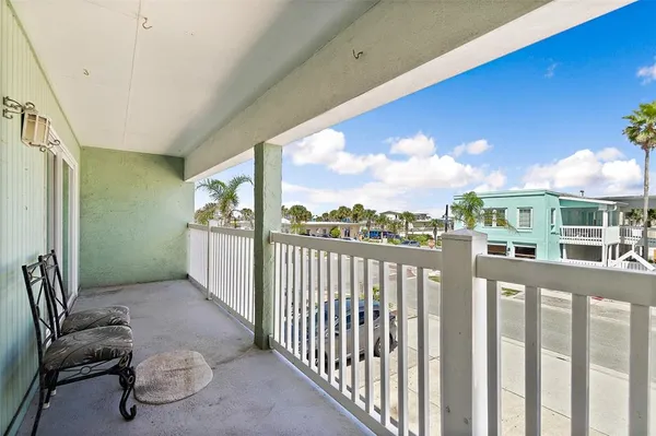 a view of a porch with furniture and a floor to ceiling window