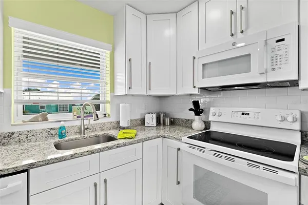 a kitchen with a sink a counter top space and cabinets