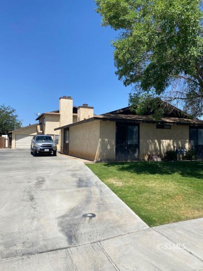 405 South Sunset Street Ridgecrest, CA 93555 - Photo 1 of 17 a car parked in front of a house