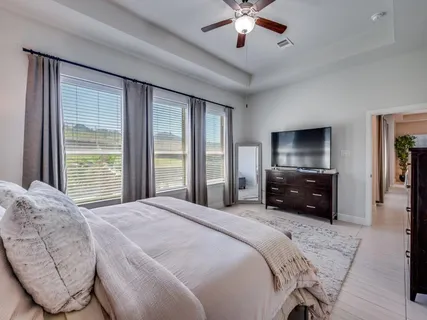 a bedroom with a bed and a chandelier
