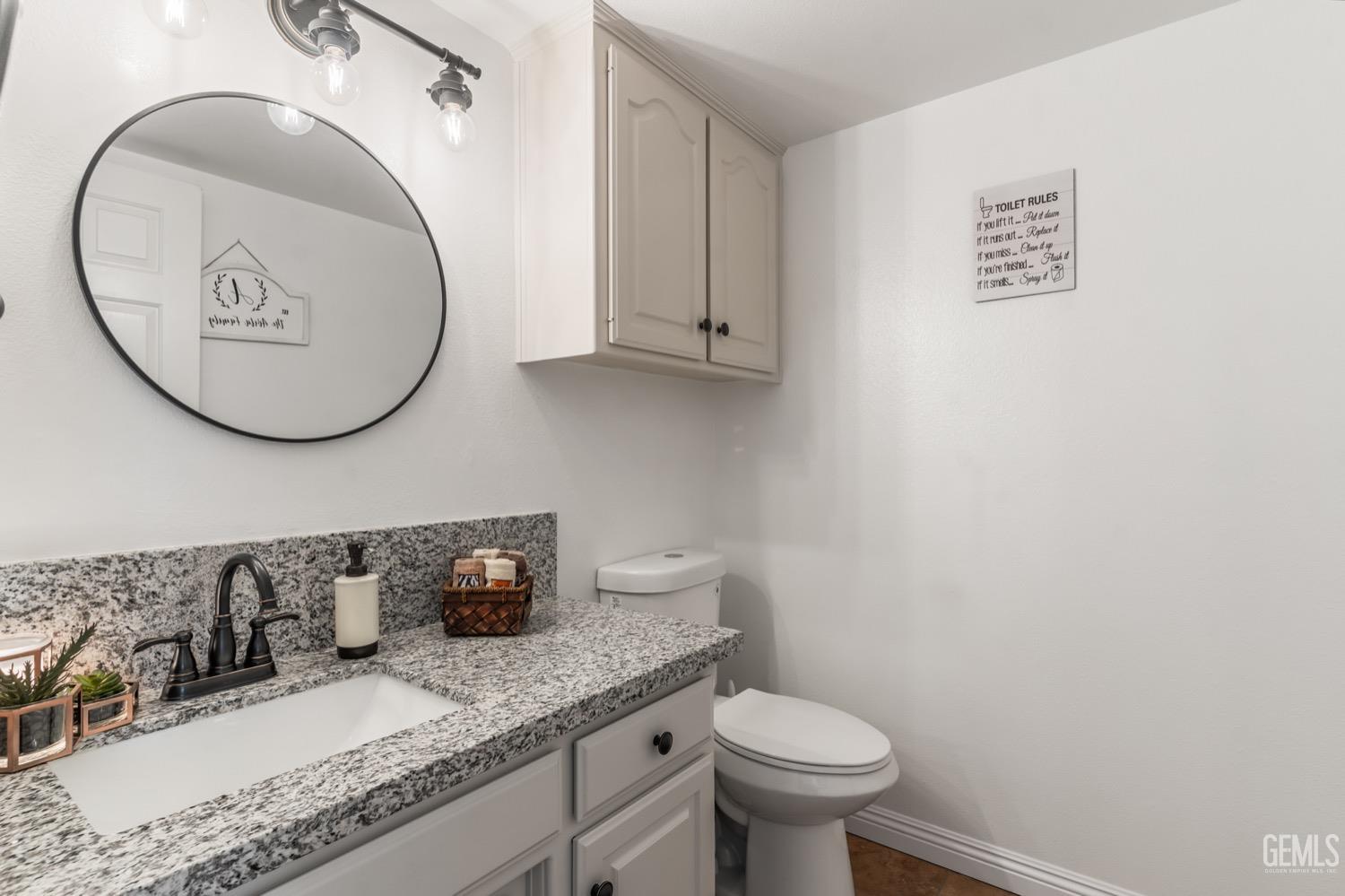 Undisclosed Address Bakersfield, CA 93312 - Photo 11 of 29 a bathroom with a granite countertop sink and a mirror