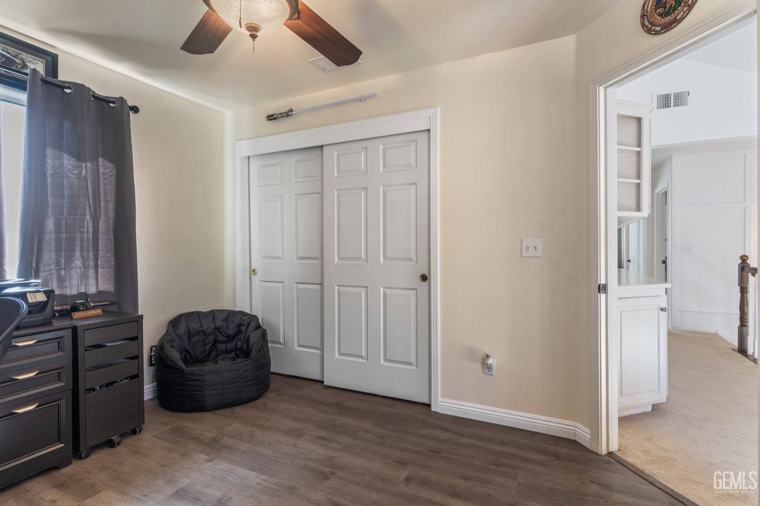 Undisclosed Address Bakersfield, CA 93312 - Photo 12 of 29 a bedroom with a bed and a chandelier