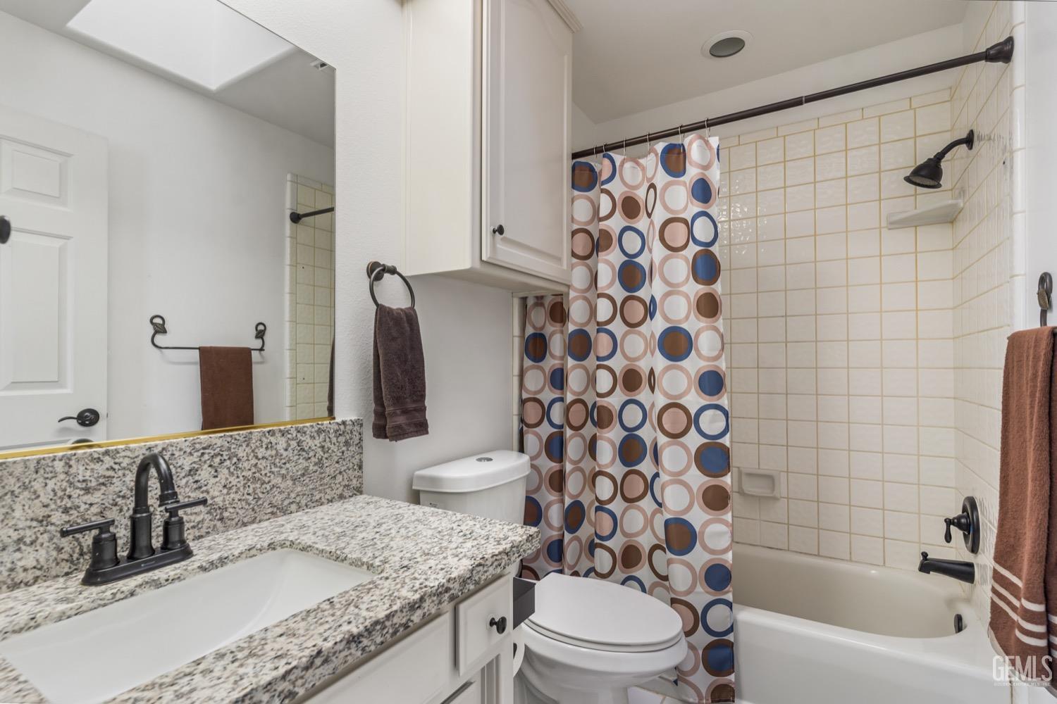 Undisclosed Address Bakersfield, CA 93312 - Photo 15 of 29 a bathroom with a granite countertop toilet sink and mirror
