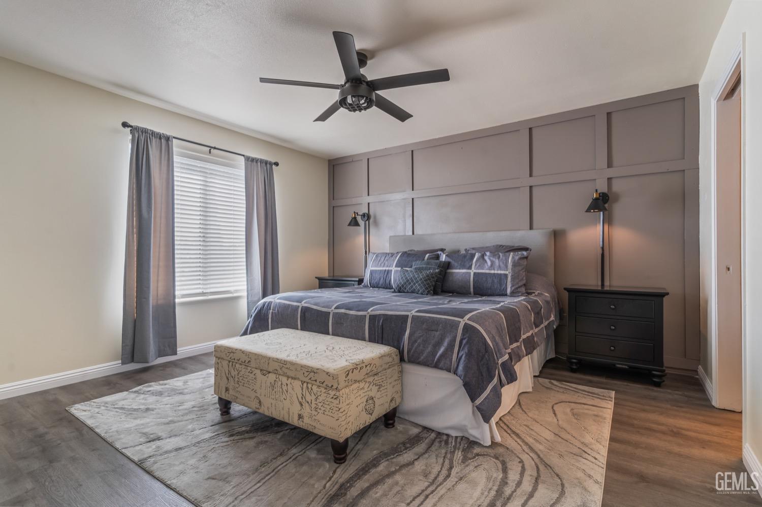 Undisclosed Address Bakersfield, CA 93312 - Photo 17 of 29 a bedroom with a bed and wooden floor