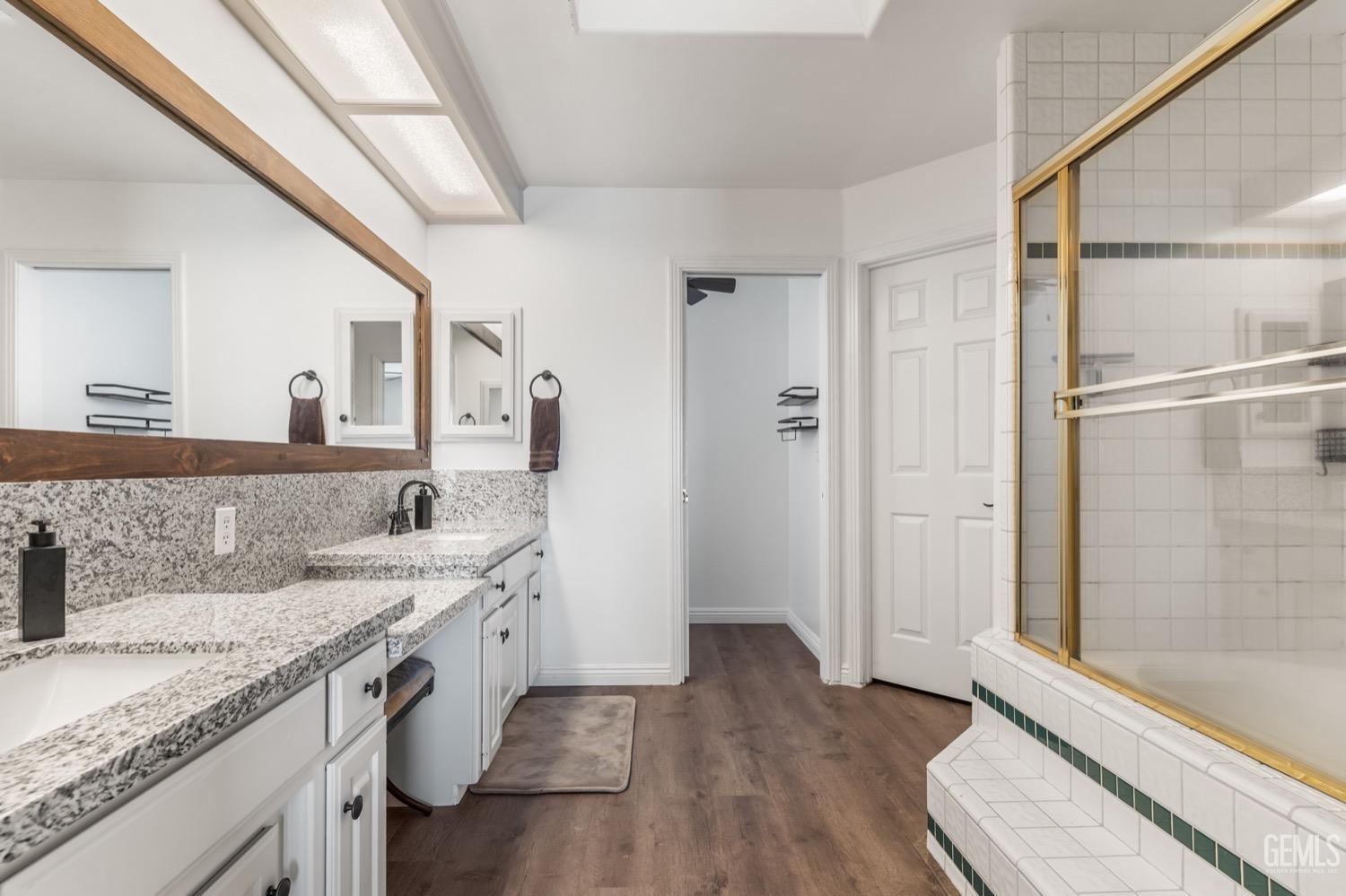 Undisclosed Address Bakersfield, CA 93312 - Photo 18 of 29 a bathroom with a granite countertop sink toilet and shower