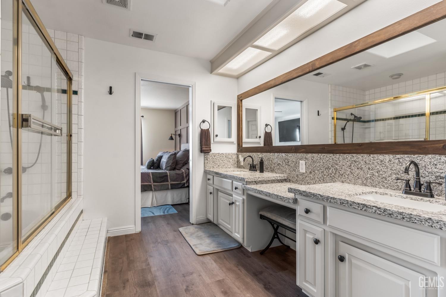 Undisclosed Address Bakersfield, CA 93312 - Photo 19 of 29 a spacious bathroom with a granite countertop sink mirror and double
