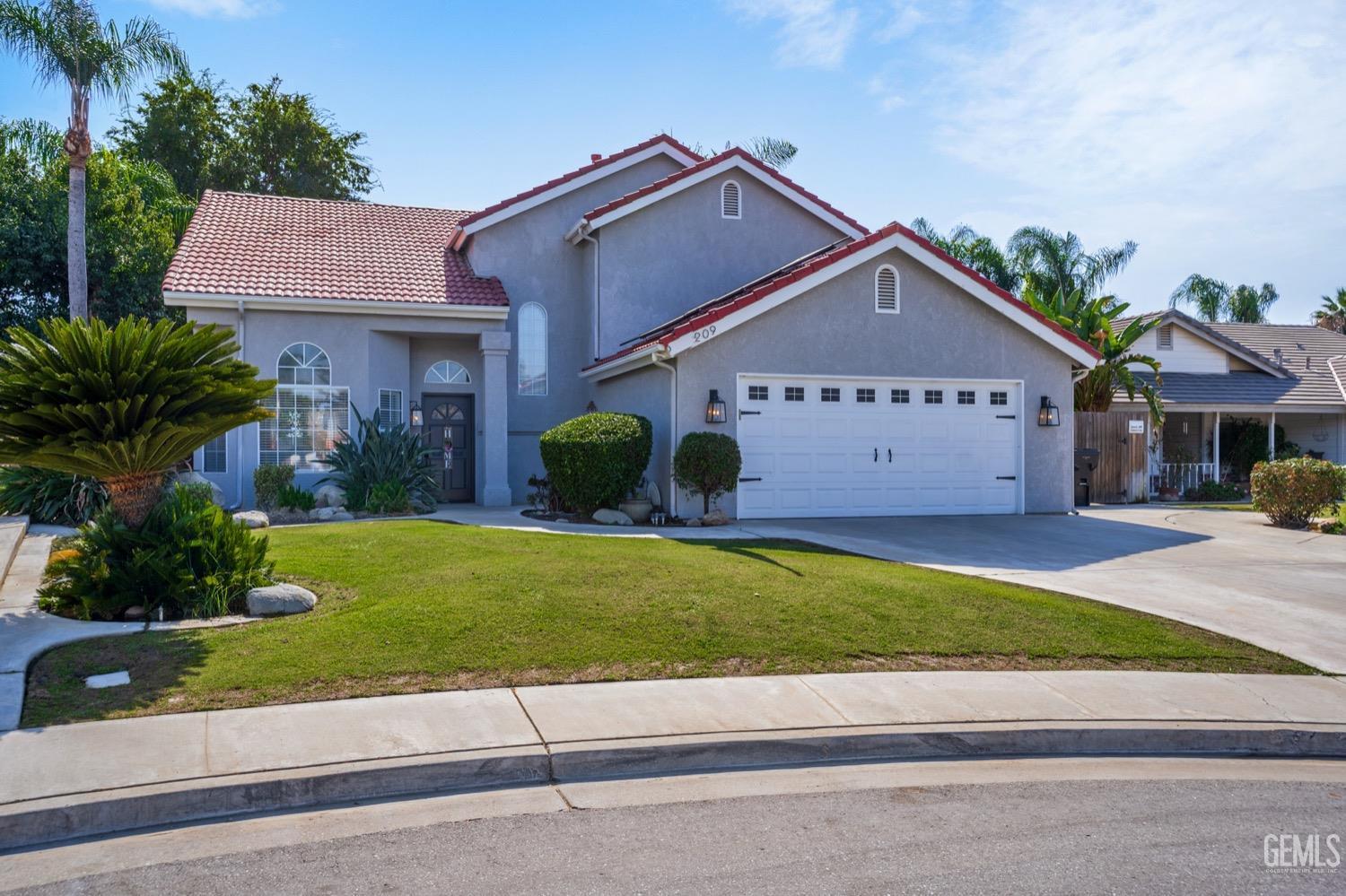 Undisclosed Address Bakersfield, CA 93312 - Photo 2 of 29 a front view of a house with a yard and garage