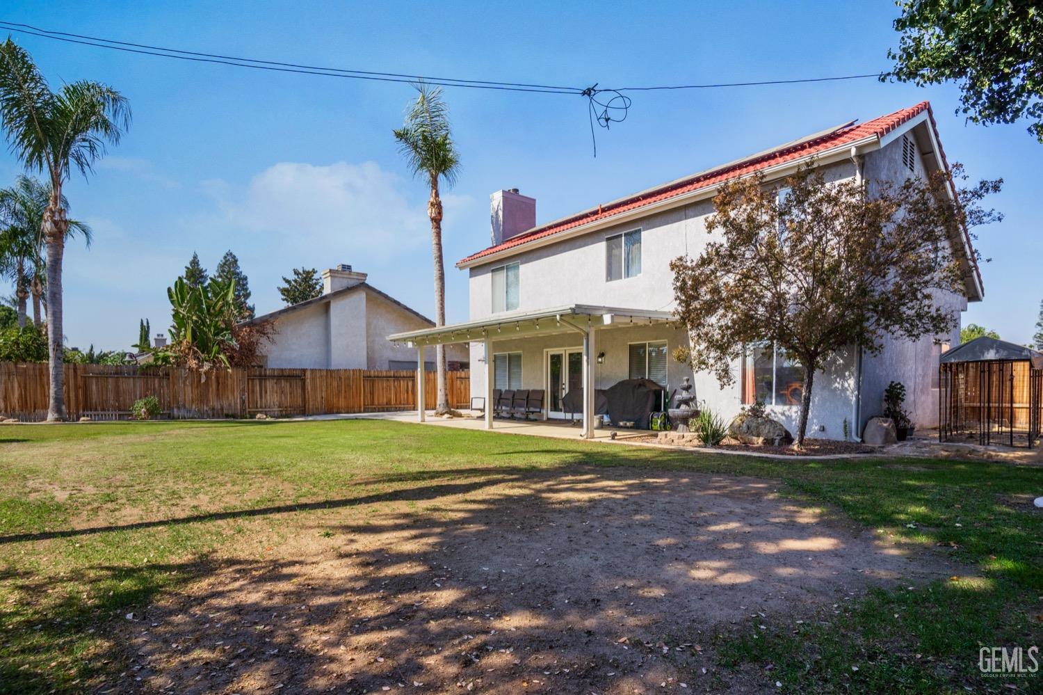 Undisclosed Address Bakersfield, CA 93312 - Photo 23 of 29 a front view of a house with a yard and garage
