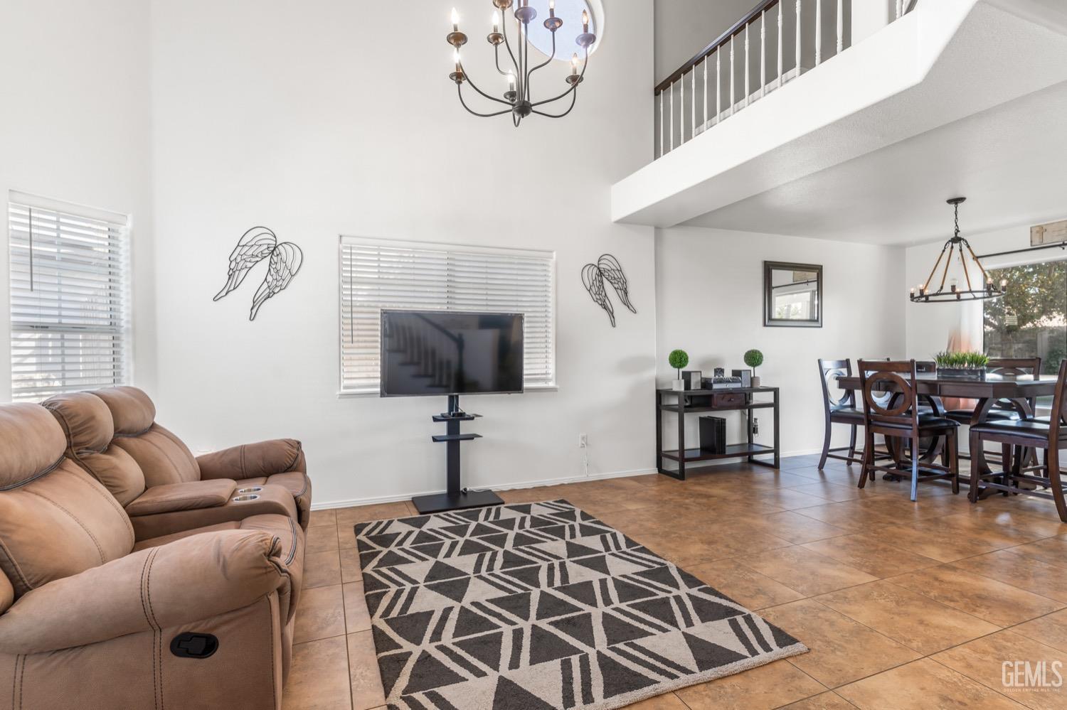 Undisclosed Address Bakersfield, CA 93312 - Photo 3 of 29 a living room with furniture a dining table and a chandelier