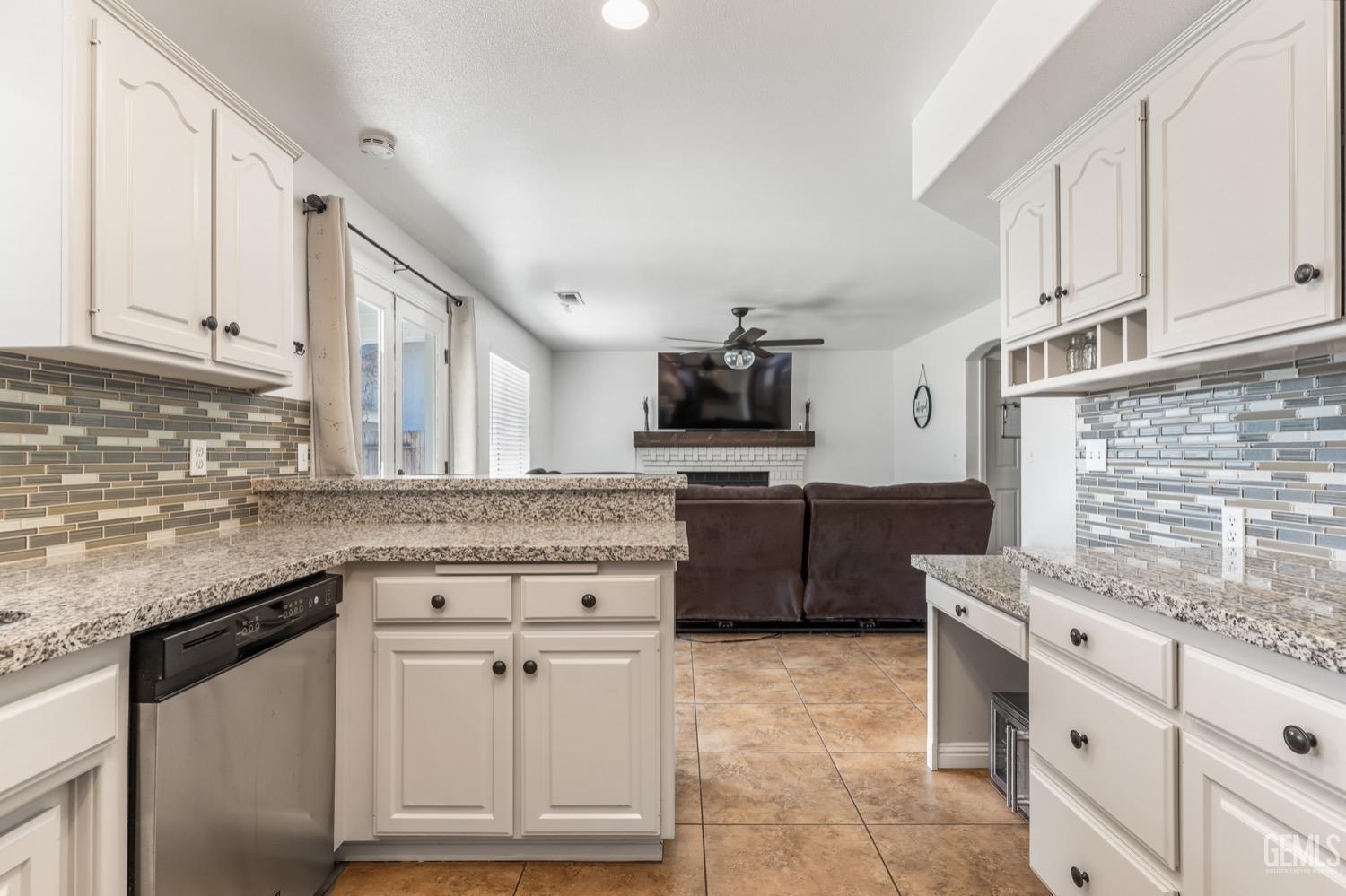Undisclosed Address Bakersfield, CA 93312 - Photo 7 of 29 a kitchen with granite countertop a stove sink and cabinets
