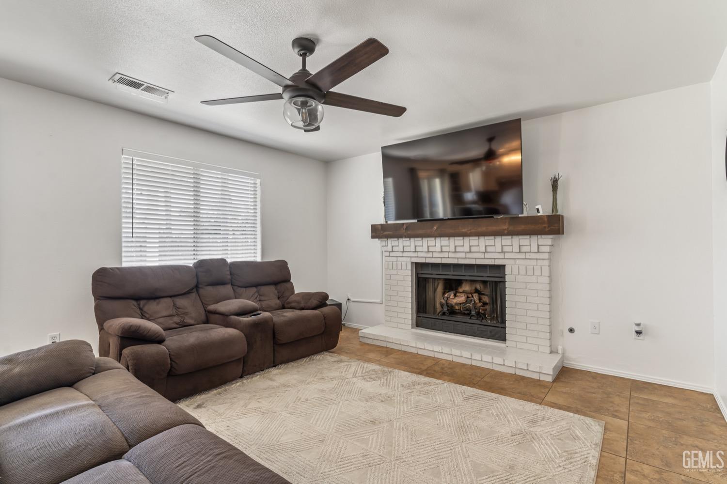 Undisclosed Address Bakersfield, CA 93312 - Photo 10 of 29 a living room with furniture and a fireplace
