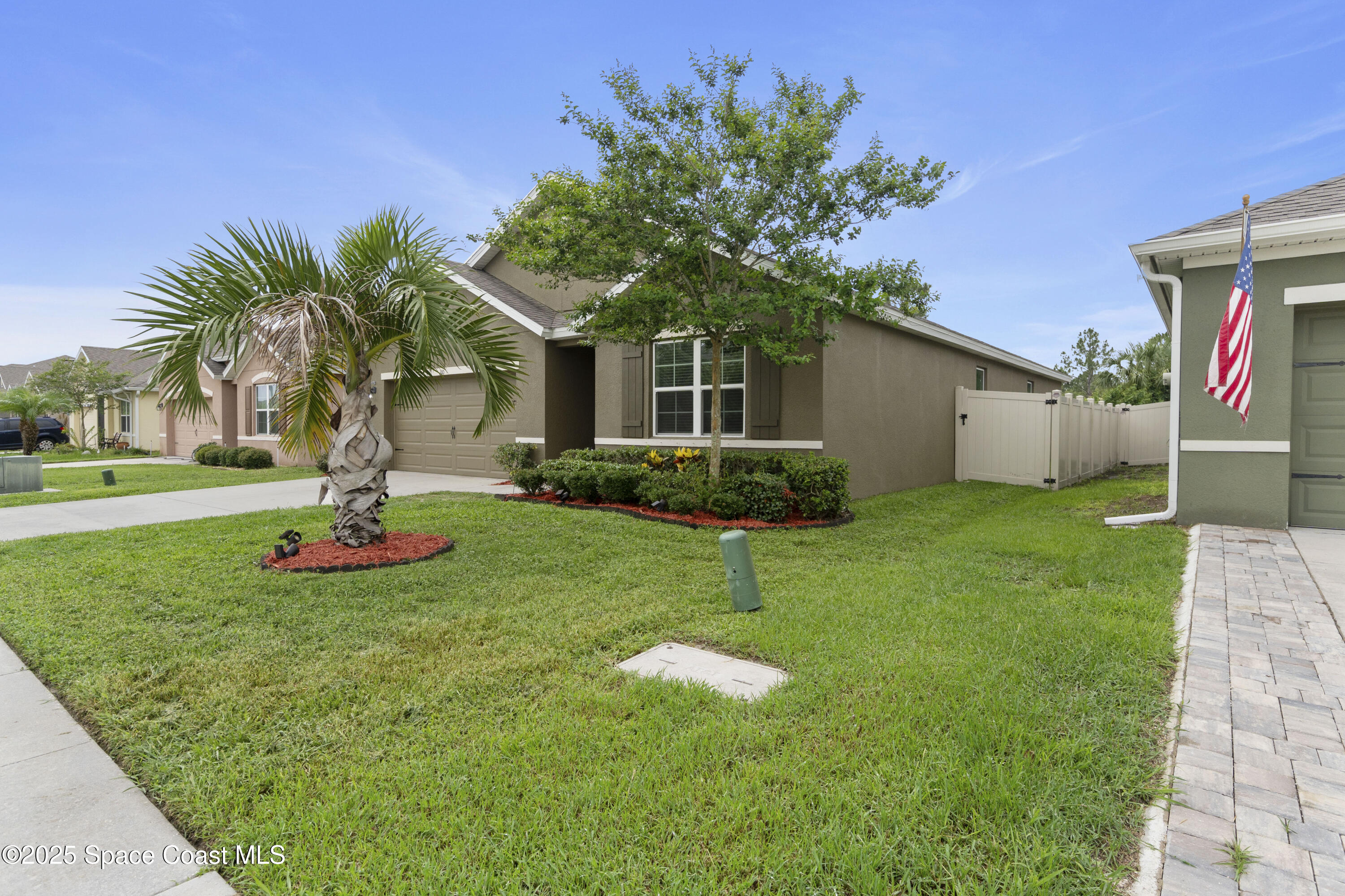 310 Forest Trace Circle Titusville, FL 32780 - Photo 2 of 36 a front view of a house with a yard and potted plants