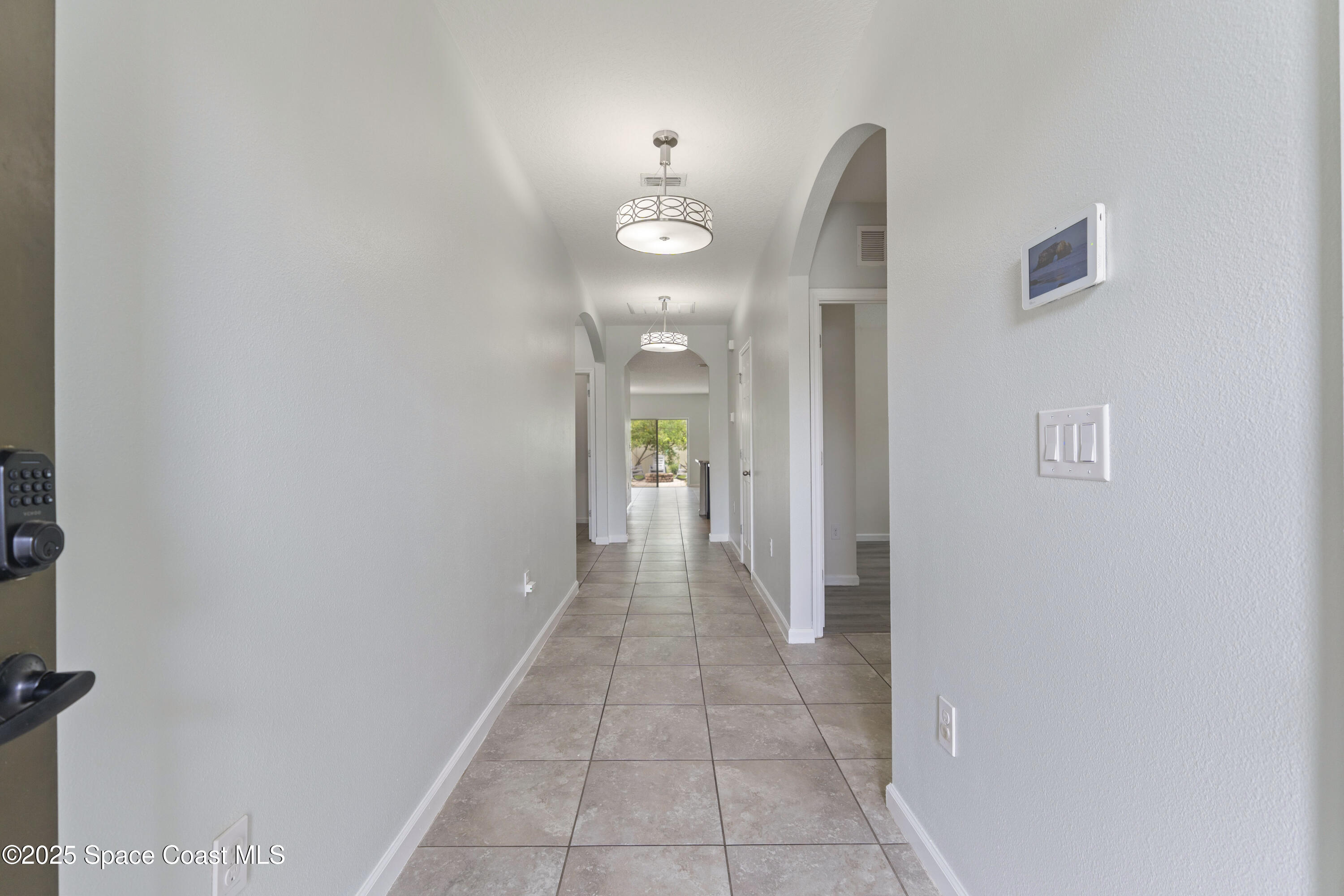 310 Forest Trace Circle Titusville, FL 32780 - Photo 22 of 36 a view of a hallway with wooden floor