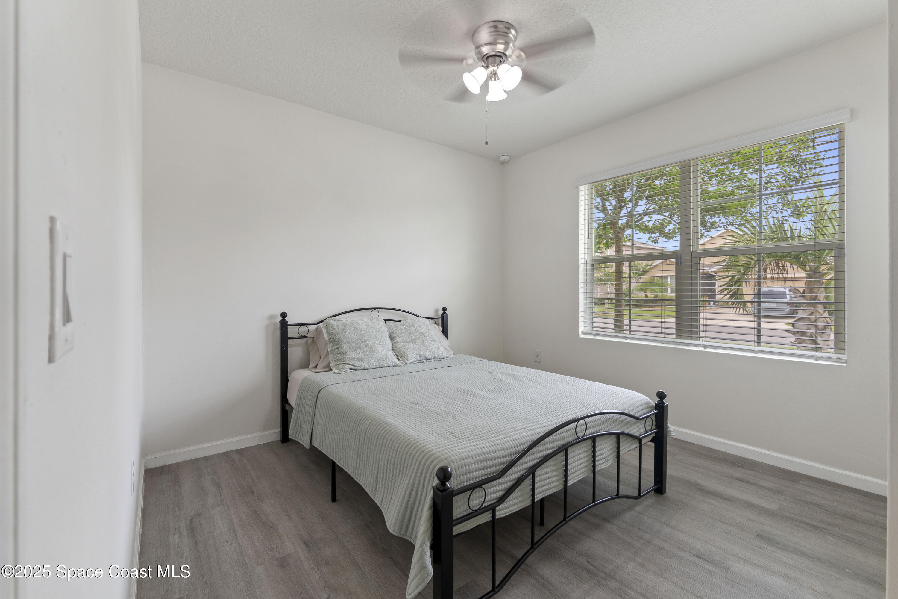 310 Forest Trace Circle Titusville, FL 32780 - Photo 26 of 36 a bedroom with a bed and a window