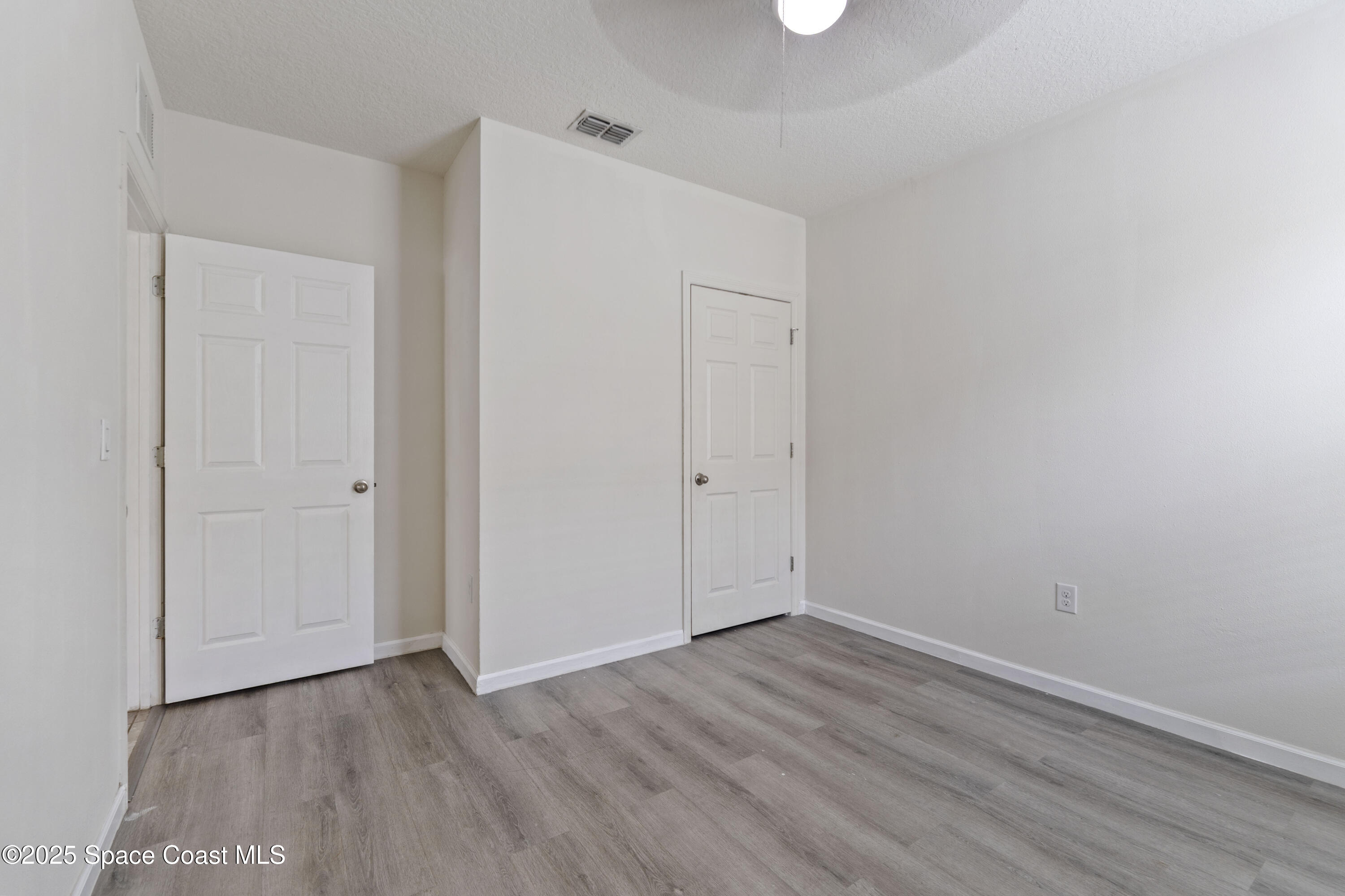 310 Forest Trace Circle Titusville, FL 32780 - Photo 30 of 36 a view of an empty room with wooden floor