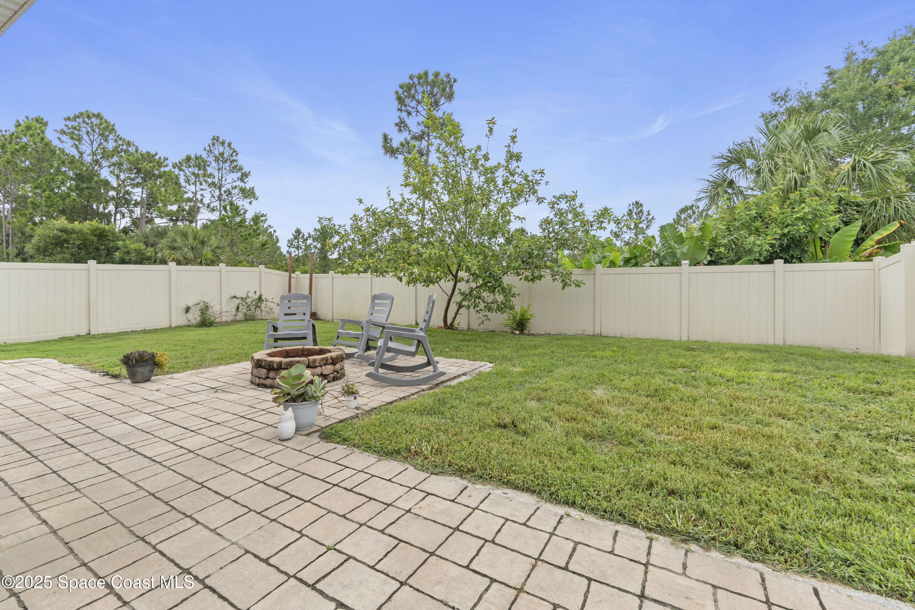 310 Forest Trace Circle Titusville, FL 32780 - Photo 35 of 36 a view of a backyard with plants and a bench