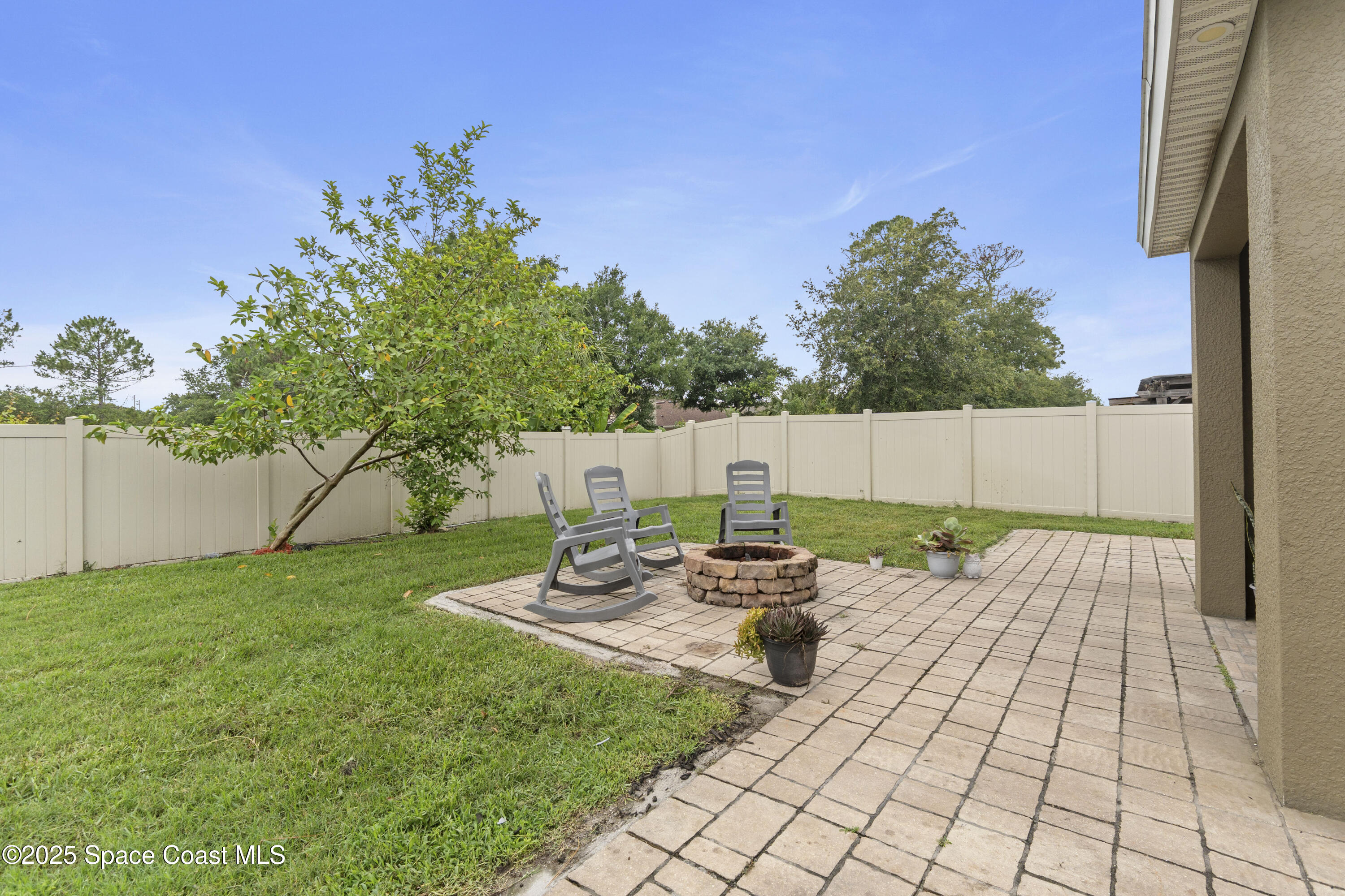 310 Forest Trace Circle Titusville, FL 32780 - Photo 36 of 36 a backyard of a house with table and chairs