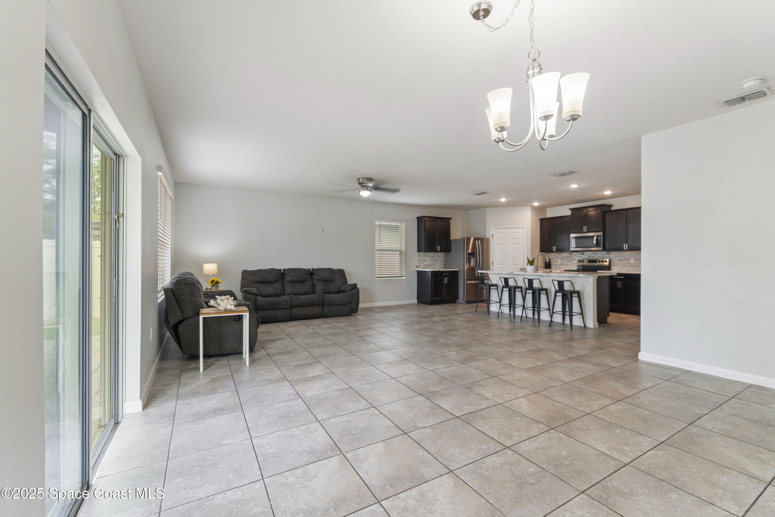 310 Forest Trace Circle Titusville, FL 32780 - Photo 8 of 36 a view of kitchen with furniture and wooden floor