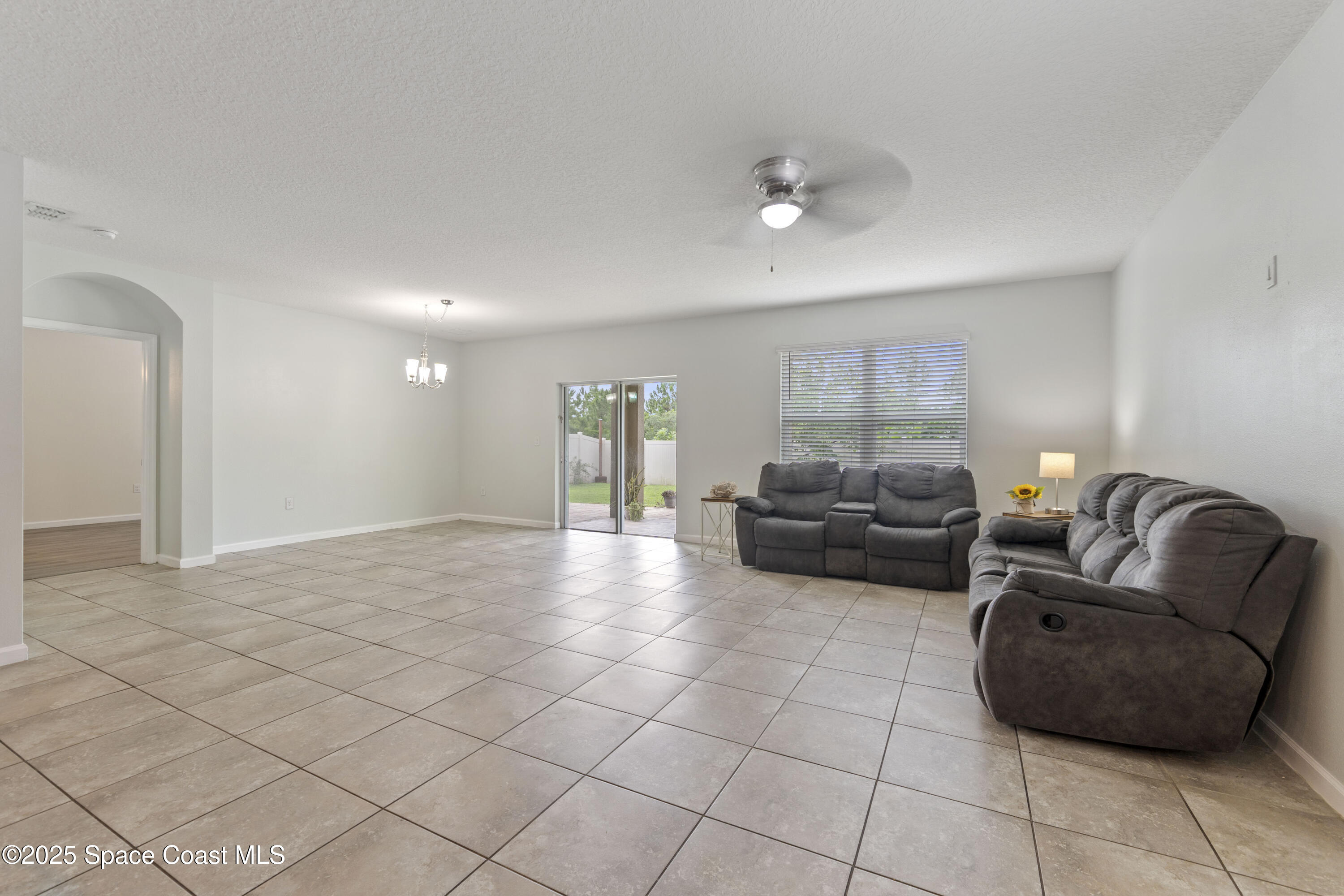 310 Forest Trace Circle Titusville, FL 32780 - Photo 10 of 36 a living room with furniture and a couch