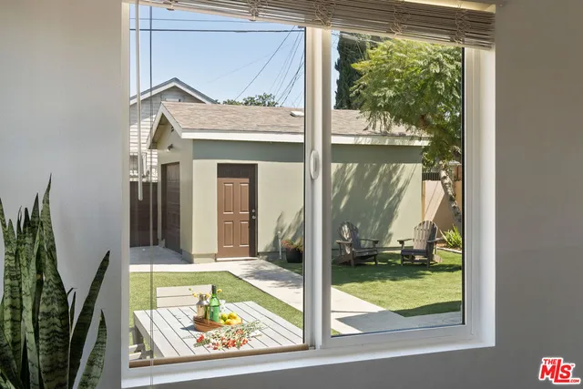a view of swimming pool with a dining table and chairs