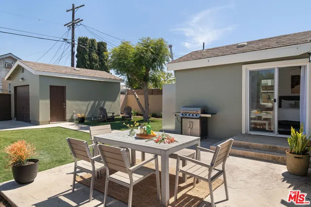 a view of a patio with table and chairs and potted plants