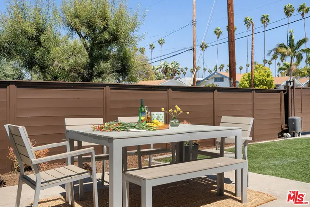 a view of an outside dining space with furniture