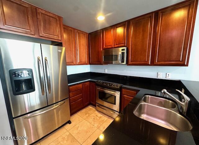 50 North Sierra Street, Unit STE 905 Reno, NV 89501 - Photo 9 of 12 a kitchen with stainless steel appliances granite countertop a refrigerator and a sink