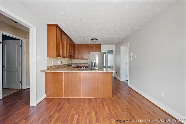 a kitchen with wooden floors and wooden cabinets