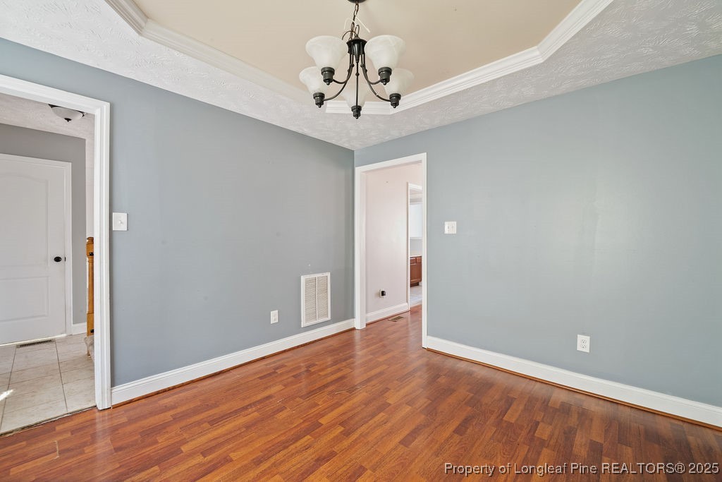 185 Sunflower Street Raeford, NC 28376 - Photo 13 of 30 a view of a room with wooden floor and chandelier
