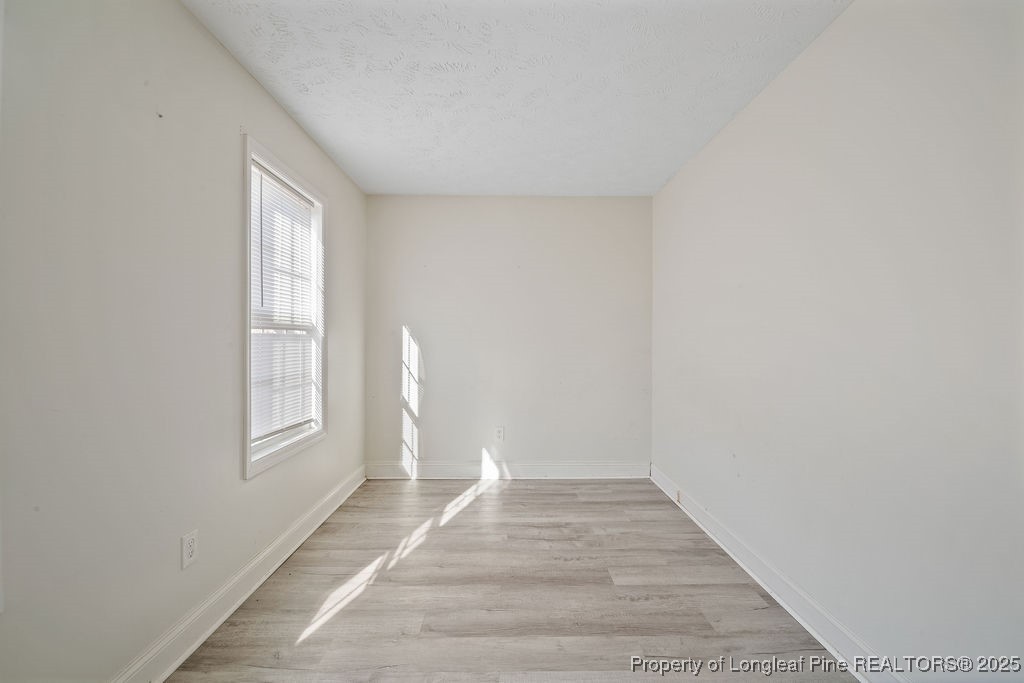 185 Sunflower Street Raeford, NC 28376 - Photo 14 of 30 a view of an empty room with wooden floor and a window